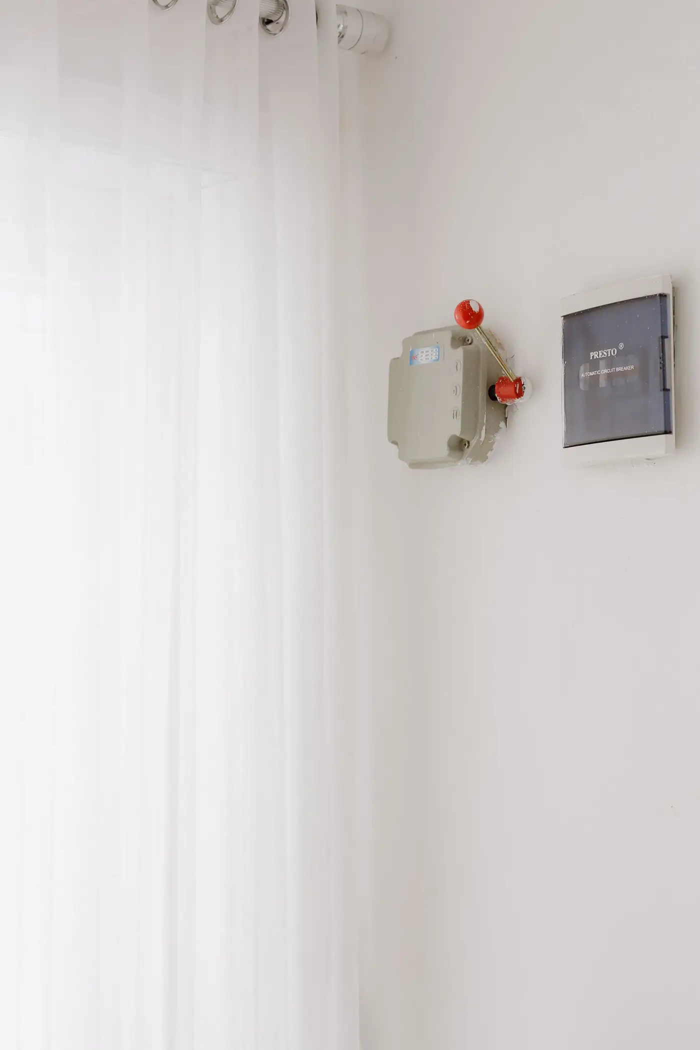 Modern switchboard with safety switches on a white wall