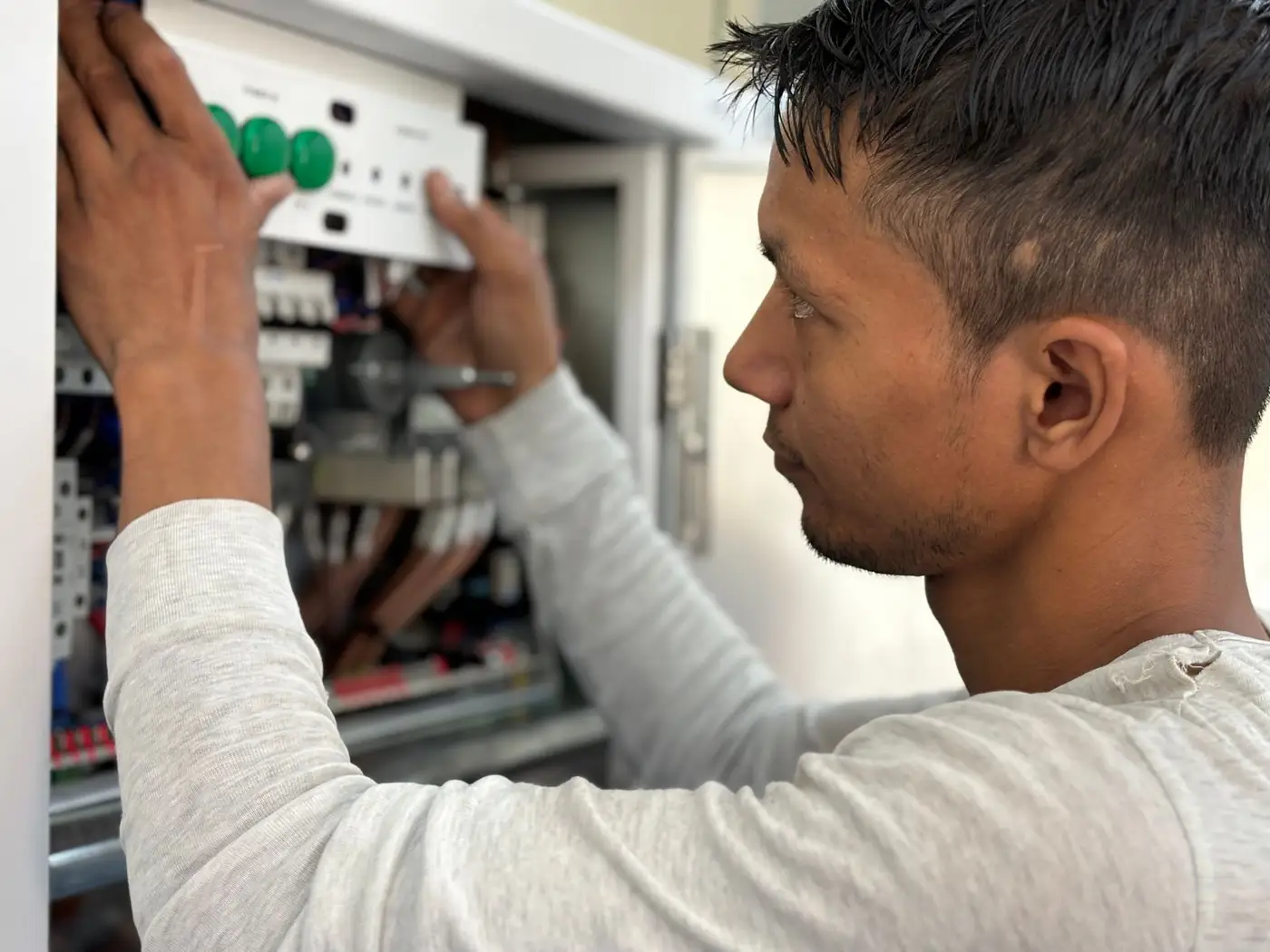 Electrician working on a circuit breaker switchboard